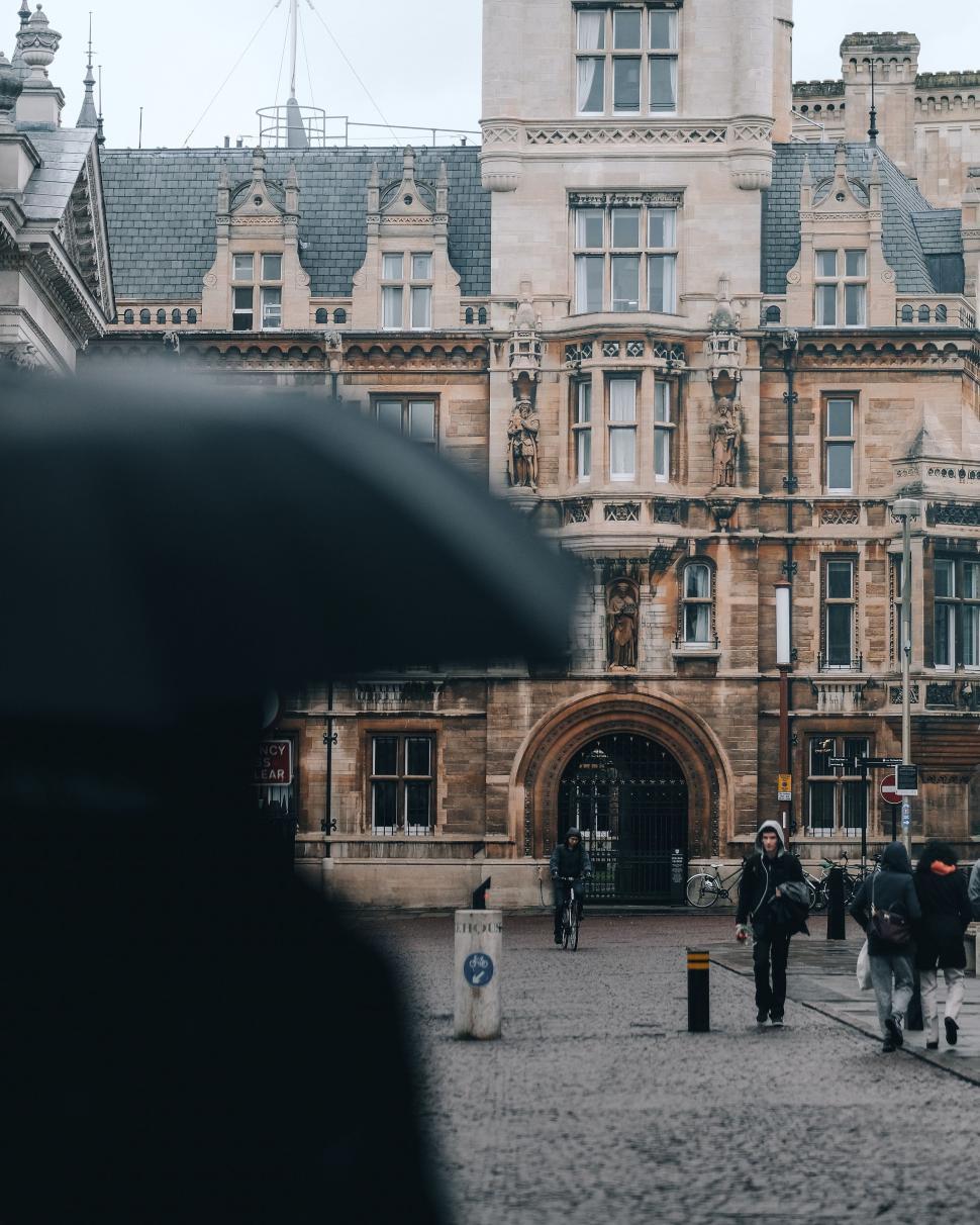 Free Image of Group of People Walking in Front of Building 