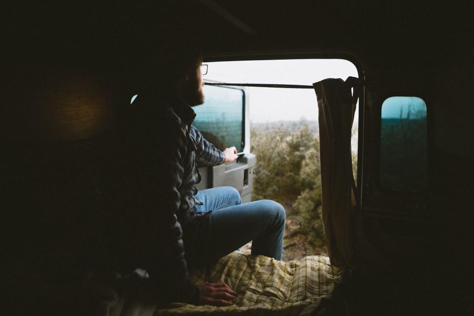 Free Image of Person Sitting in the Back of a Truck 