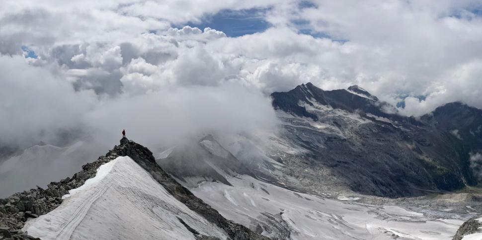 Free Image of Snow Covered Mountain With Clouds in the Sky 