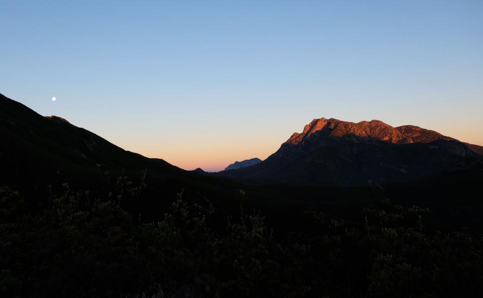 Free Image of Majestic Mountain Range Silhouetted by Sunset 