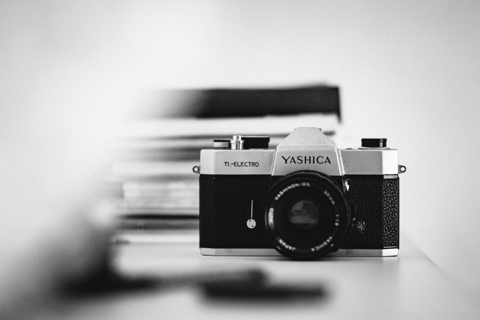 Free Image of Camera on Table With Stack of Books 