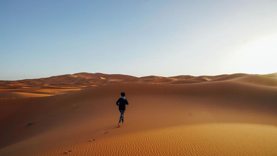 Free Image of Man Running Across Sandy Field in Desert 