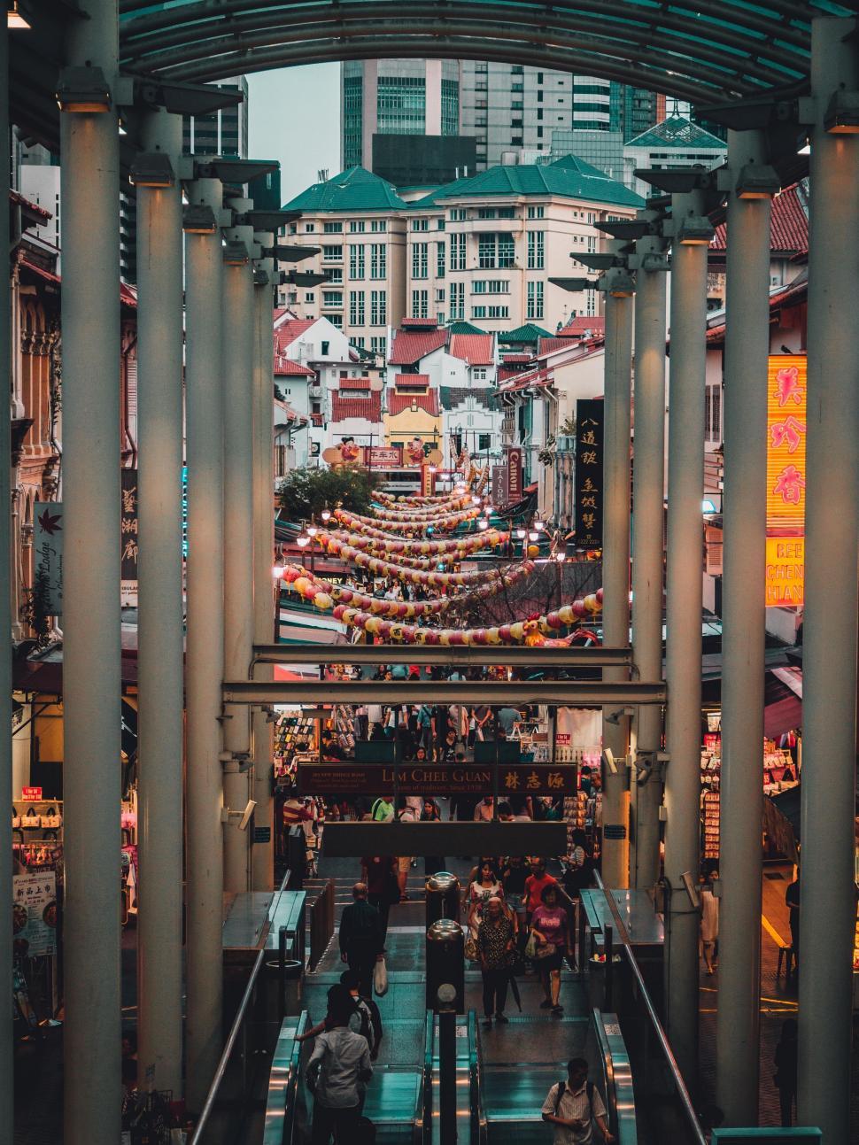 Free Image of Group of People Standing on Top of an Escalator 