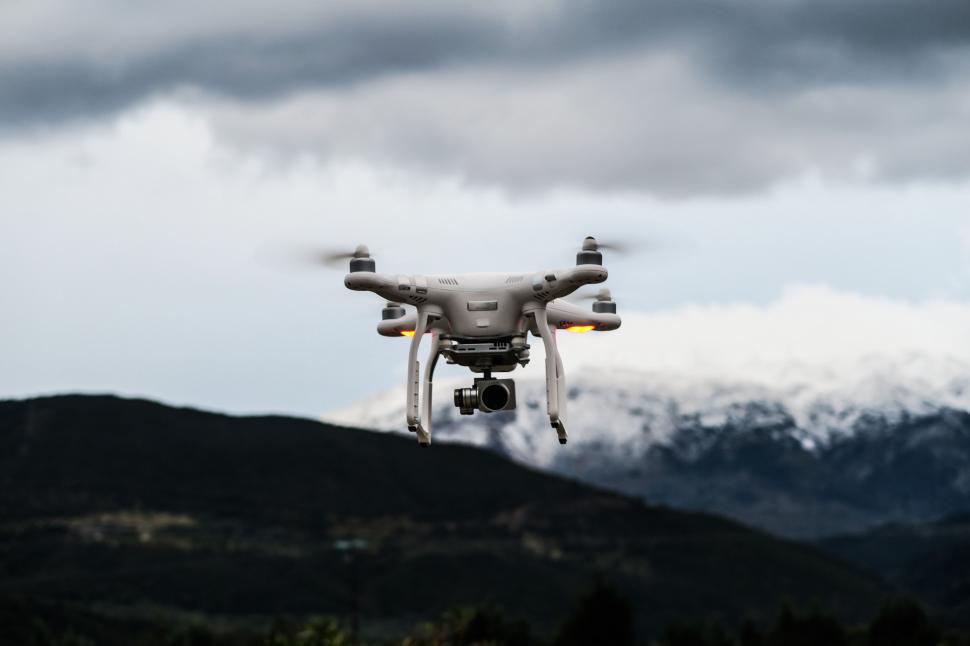 Free Image of Large Gray and Black Object Flying Over a Mountain 