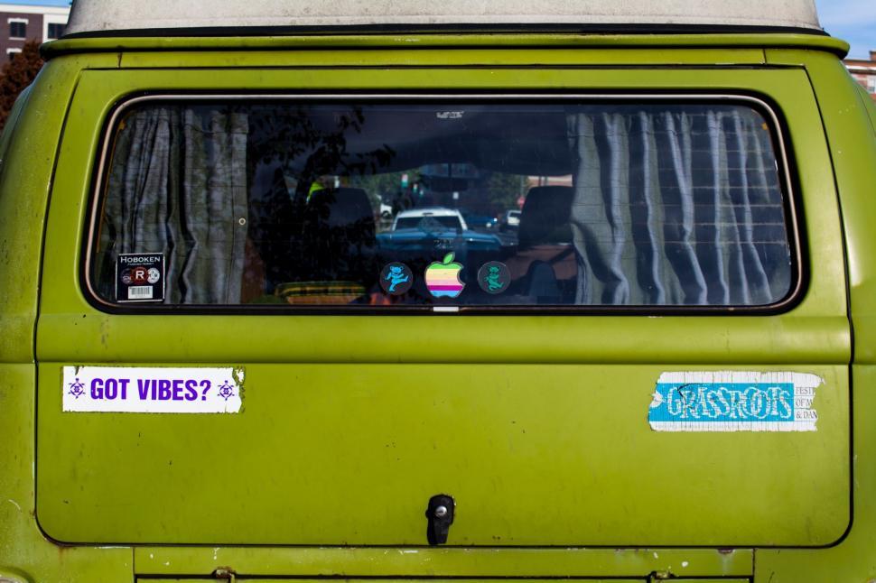 Free Image of Green Truck With White Roof and Blue Sign 