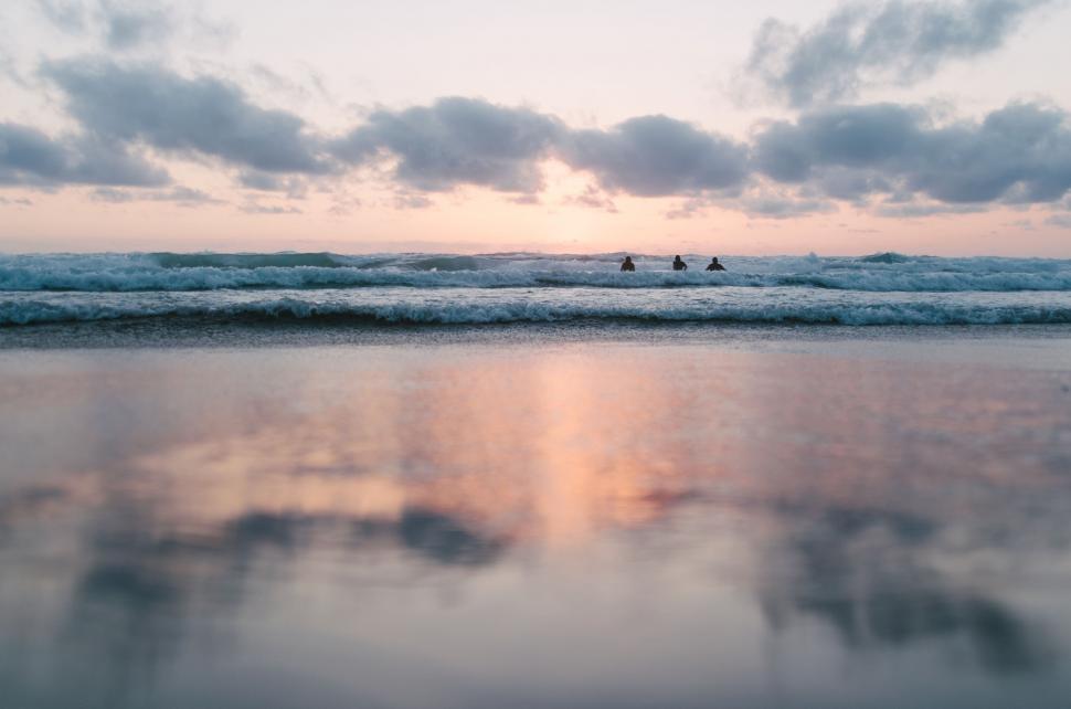 Free Image of Couple Walking Along Beach by Ocean 