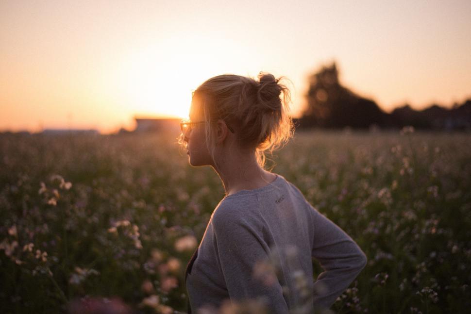 Free Image of Woman Standing in Field at Sunset 