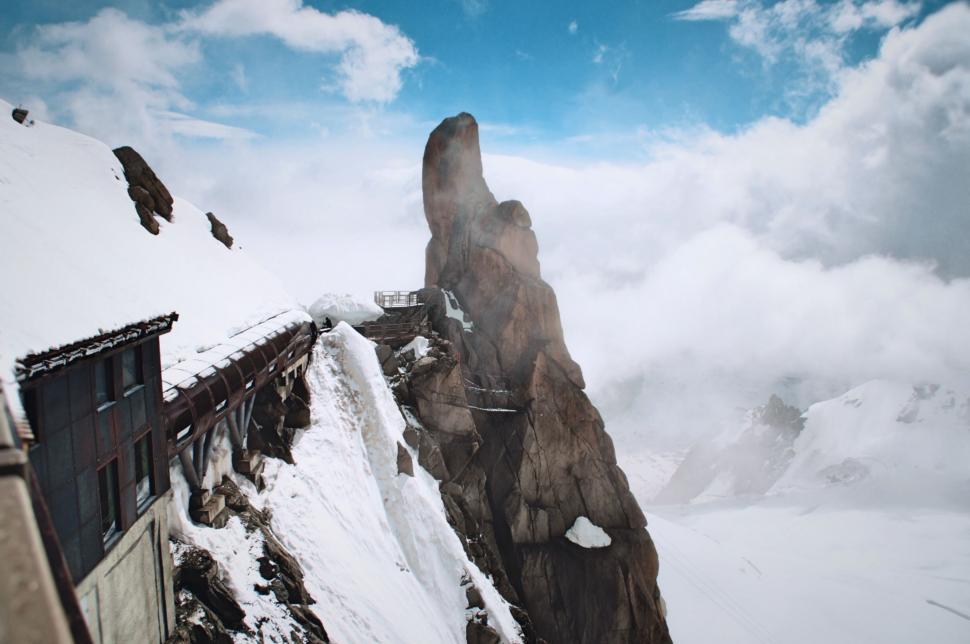 Free Image of Train Traveling Down Snow Covered Mountain Side 