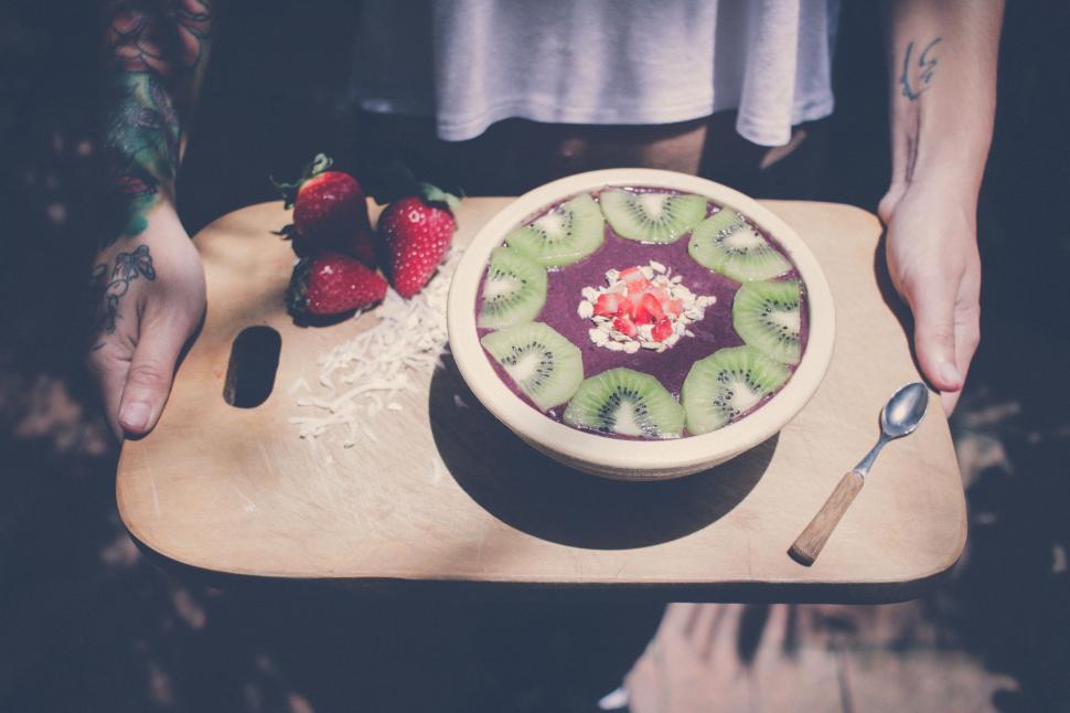 Free Image of Person Holding a Plate With a Bowl of Fruit 
