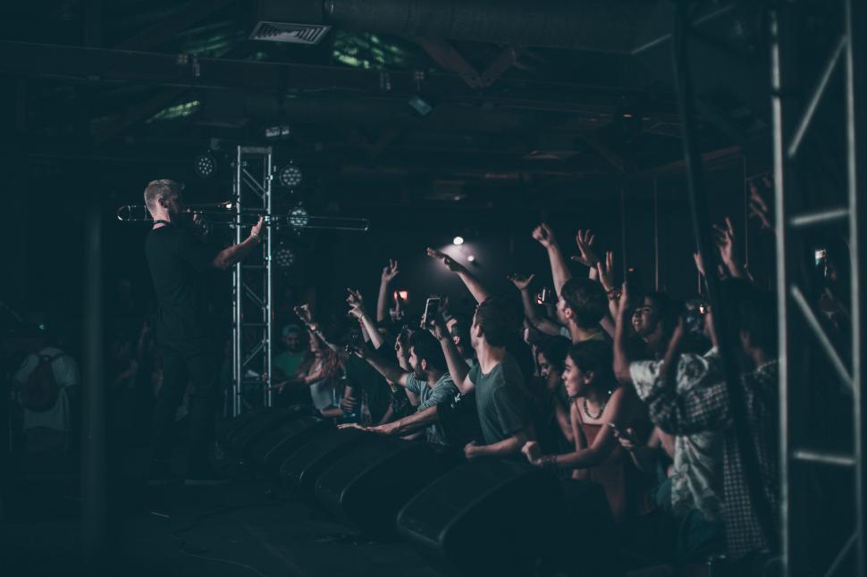 Free Image of A Crowd of People in a Dark Room 