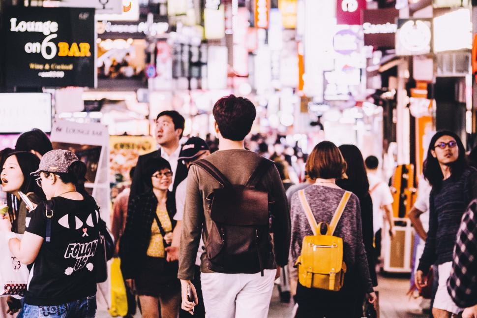 Free Image of Group of People Walking Down a Busy Street 