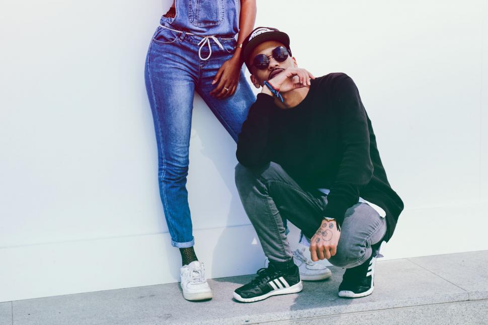 Free Image of Man and Woman Leaning Against a Wall 