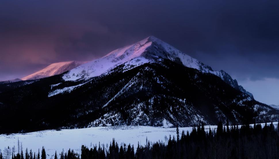 Free Image of Snow-Covered Mountain Under Cloudy Sky 