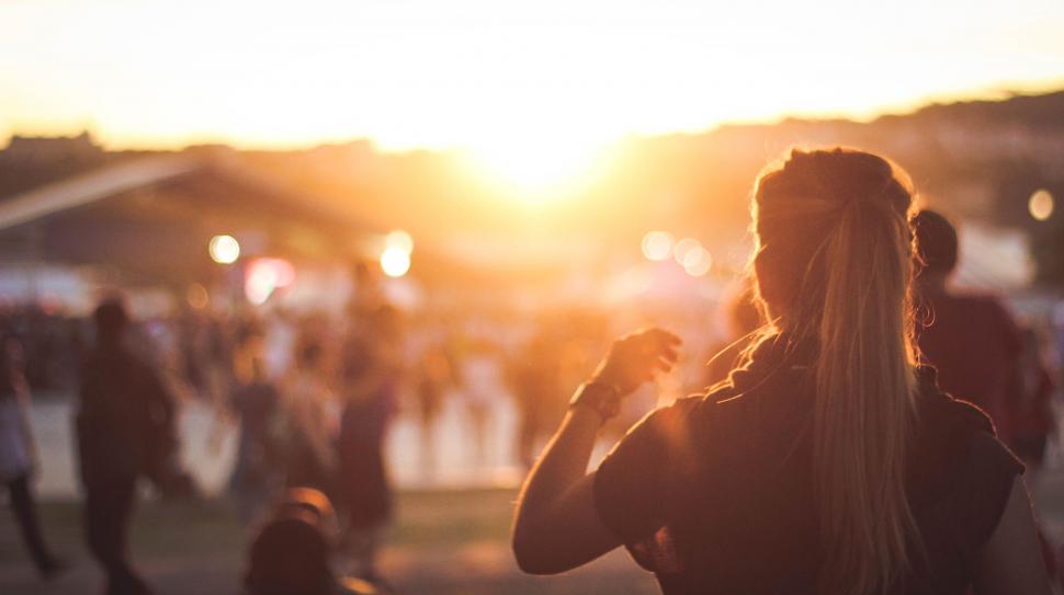Free Image of Woman Standing in Front of Crowd of People 