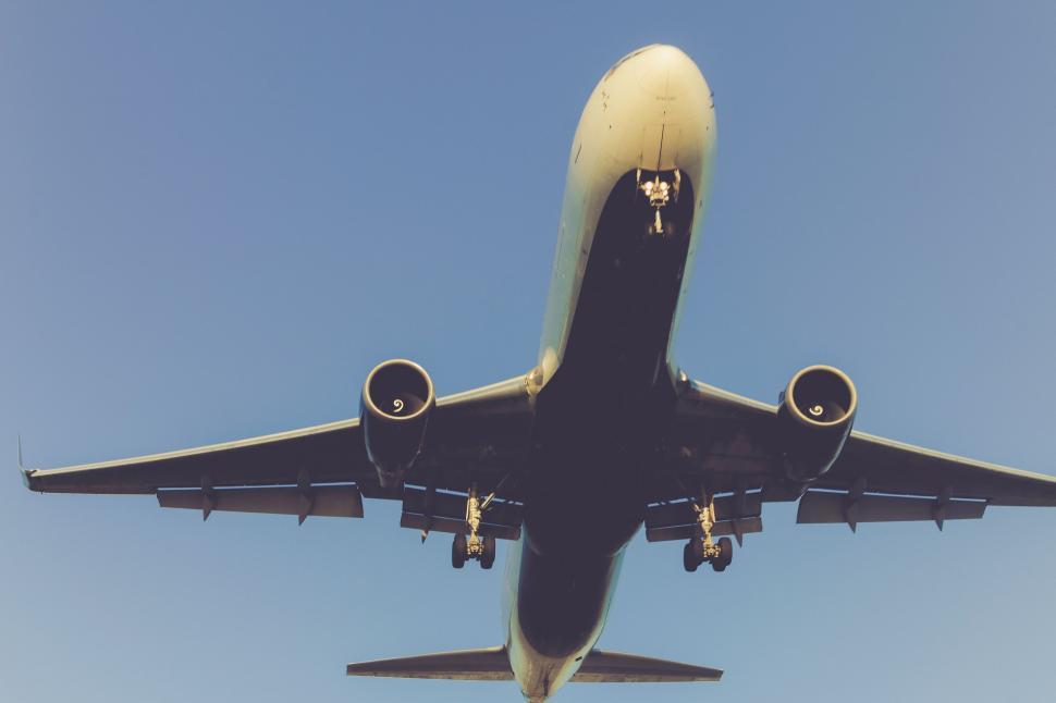 Free Image of Large Jetliner Flying Through Blue Sky 