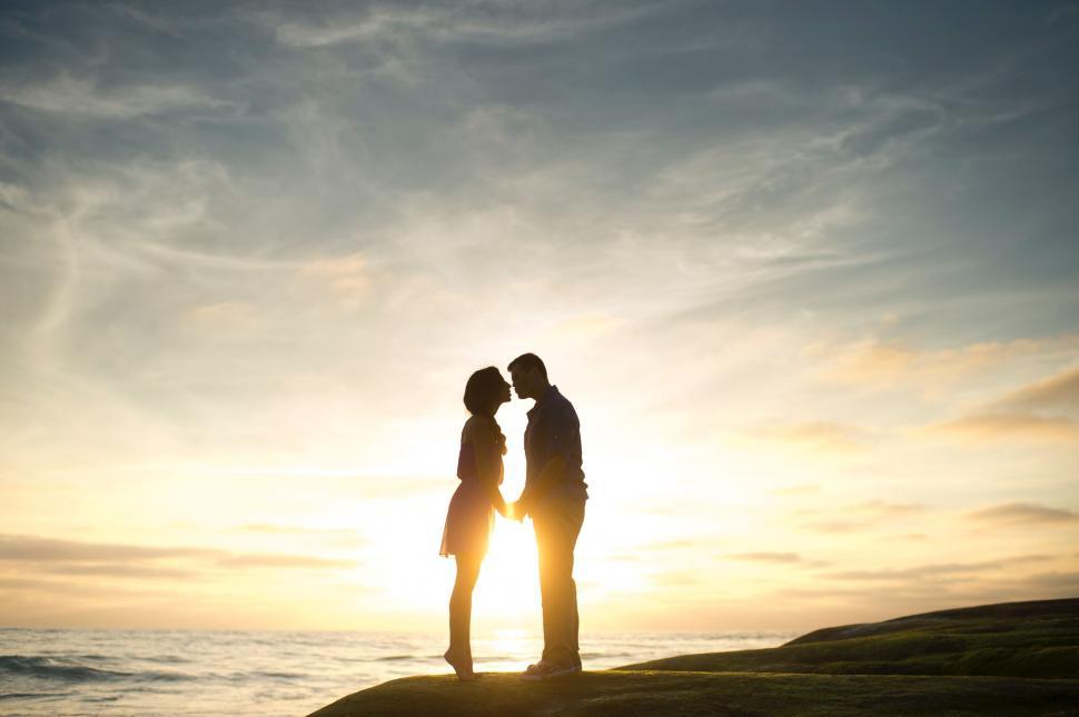 Free Image of Couple Standing on Top of Beach 