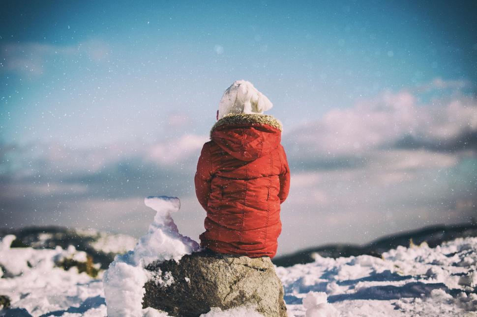 Free Image of Person Sitting on Snow Covered Hill 