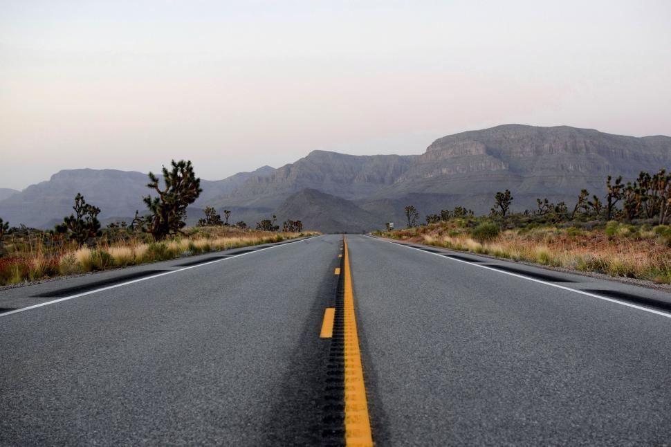 Free Image of Empty Road With Mountains in the Background 