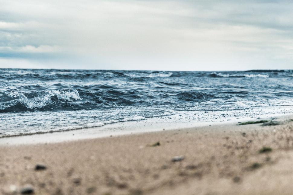 Free Image of Sandy Beach With Waves Rolling Onto Shore 