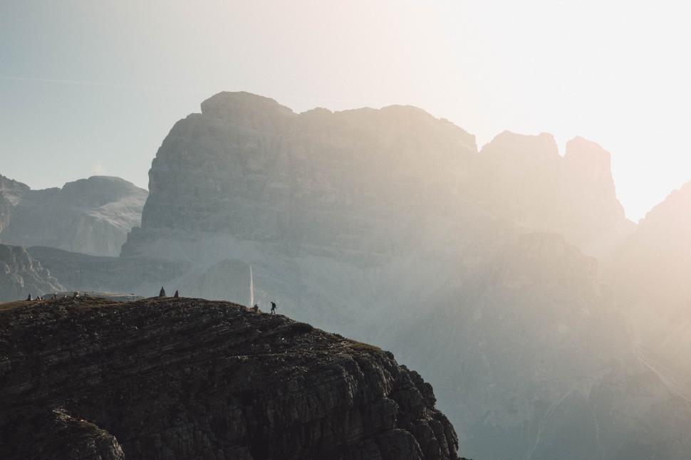 Free Image of Group of People Standing on Top of a Mountain 