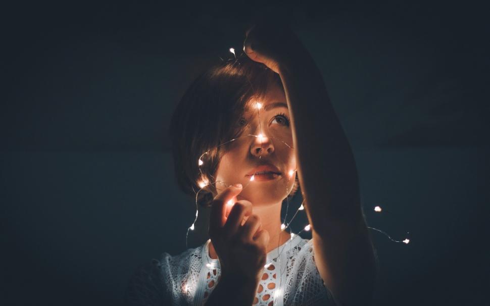 Free Image of Woman Holding Hands Up to Face 