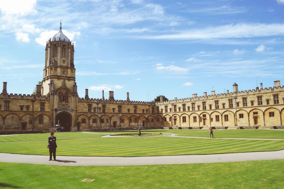 Free Image of Person Standing in Front of Large Building 
