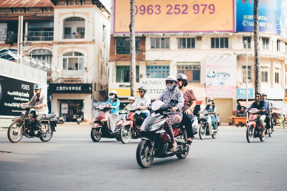 Free Image of Group of People Riding Motorcycles Down a Street 