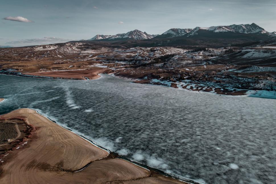 Free Image of Majestic Mountains Surrounding a Vast Body of Water 