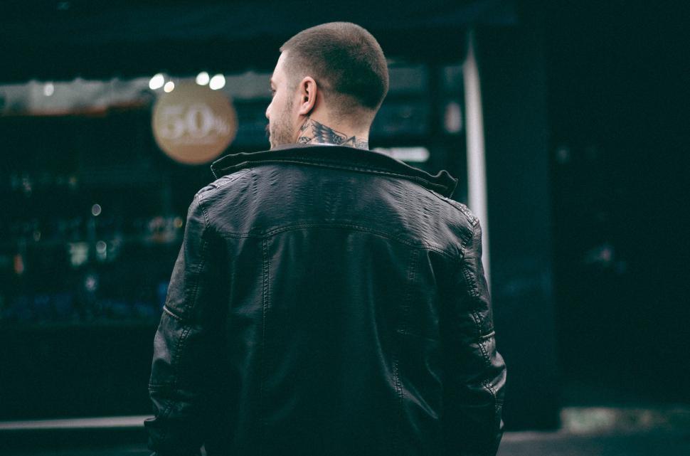Free Image of Man in Black Jacket Standing Outside 