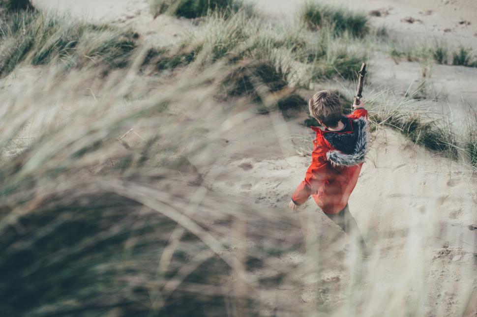 Free Image of Woman in Red Dress Walking Through Field 
