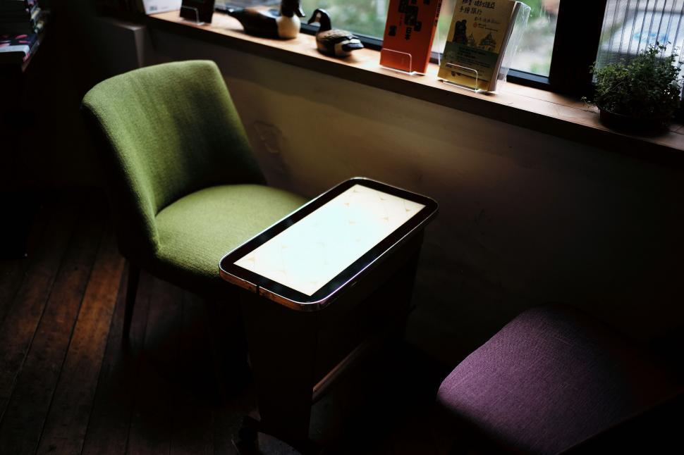 Free Image of A Green Chair by a Window 