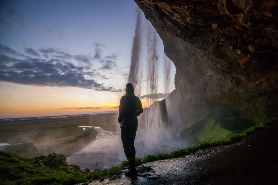 Free Image of Person Standing in Front of Waterfall 