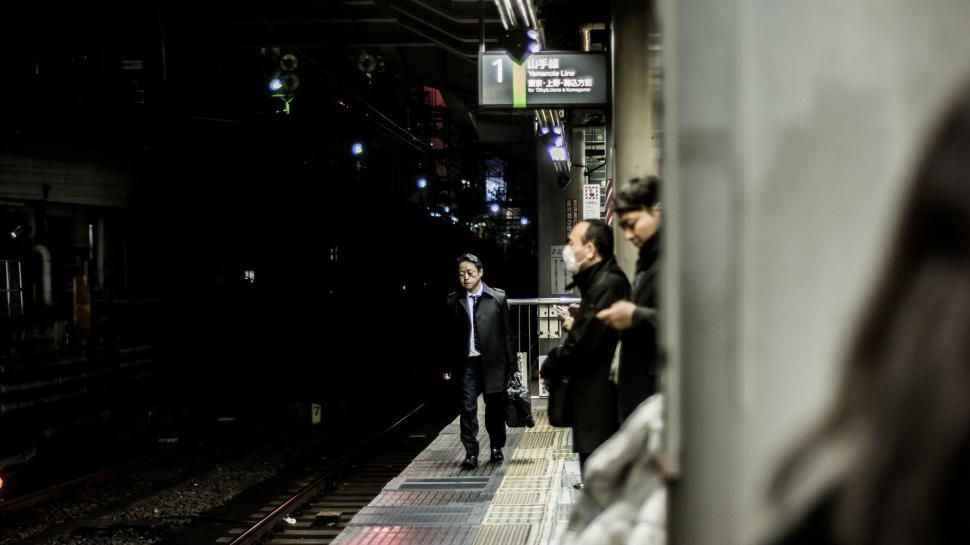 Free Image of Group of People Standing on Train Platform 