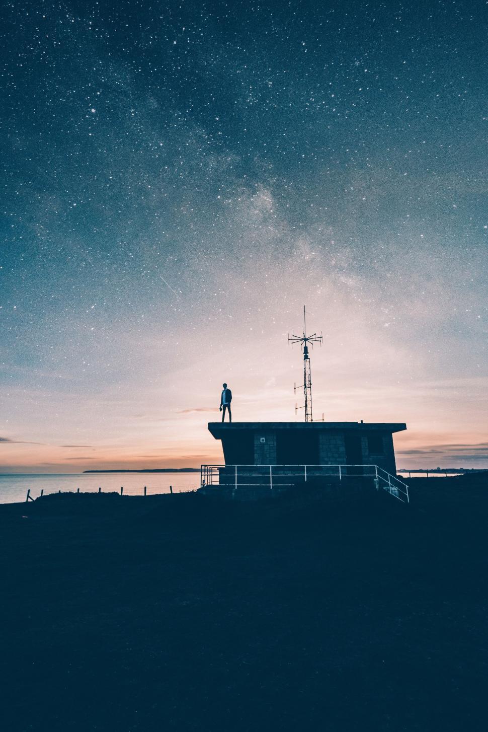 Free Image of Man Standing on Building Under Night Sky 