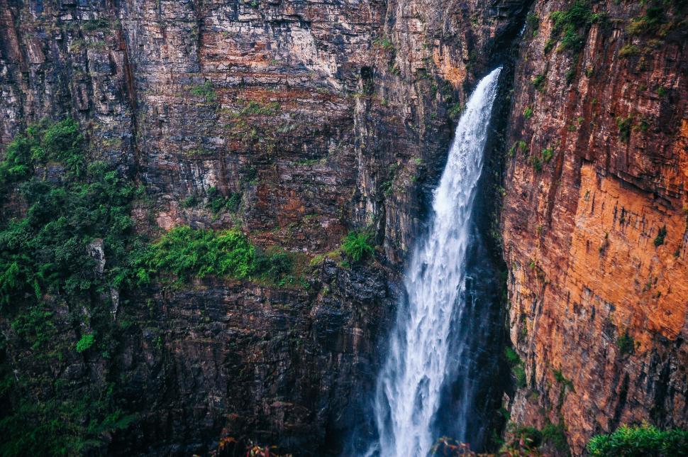 Free Image of Majestic Waterfall Flowing Through Canyon 
