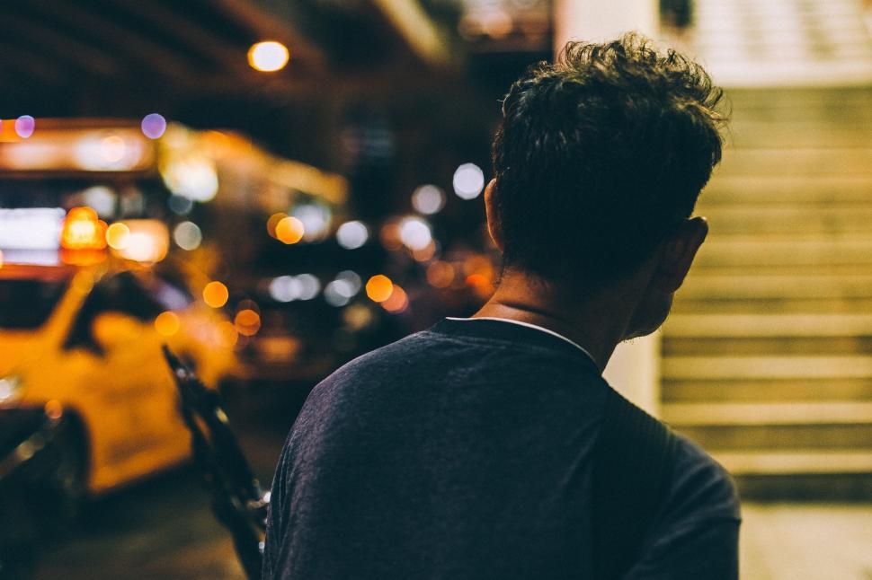 Free Image of Man Standing in Front of Yellow Taxi 
