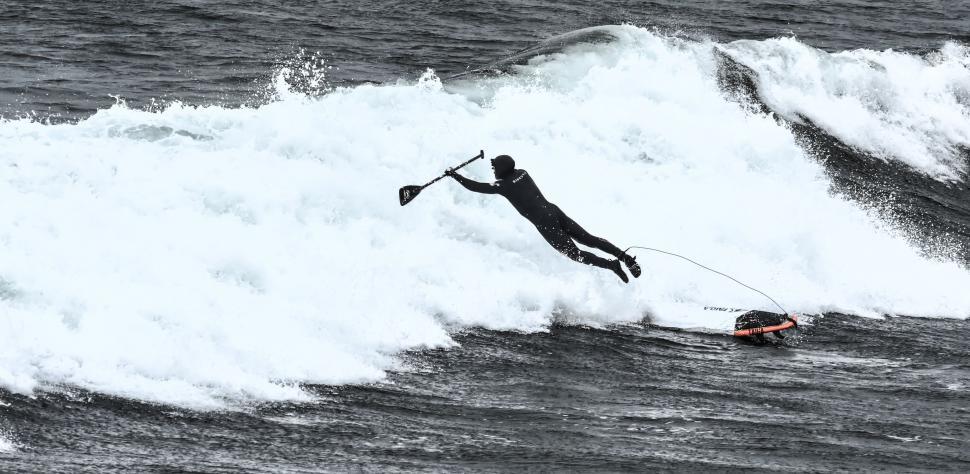 Free Image of Man Riding Wave on Surfboard 