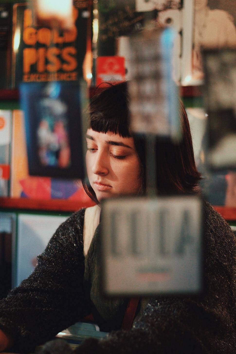 Free Image of Woman Sitting at Table With Eyes Closed 