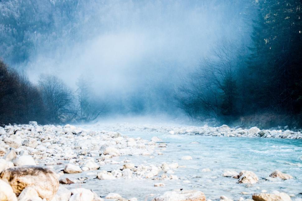Free Image of River Flowing Through Snow-Covered Forest 