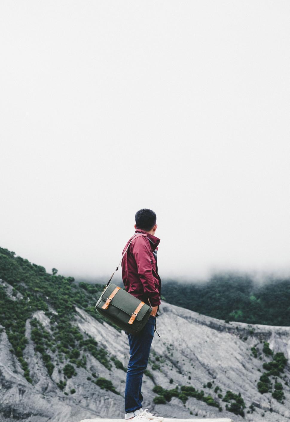 Free Image of Man Standing on Snow Covered Slope 