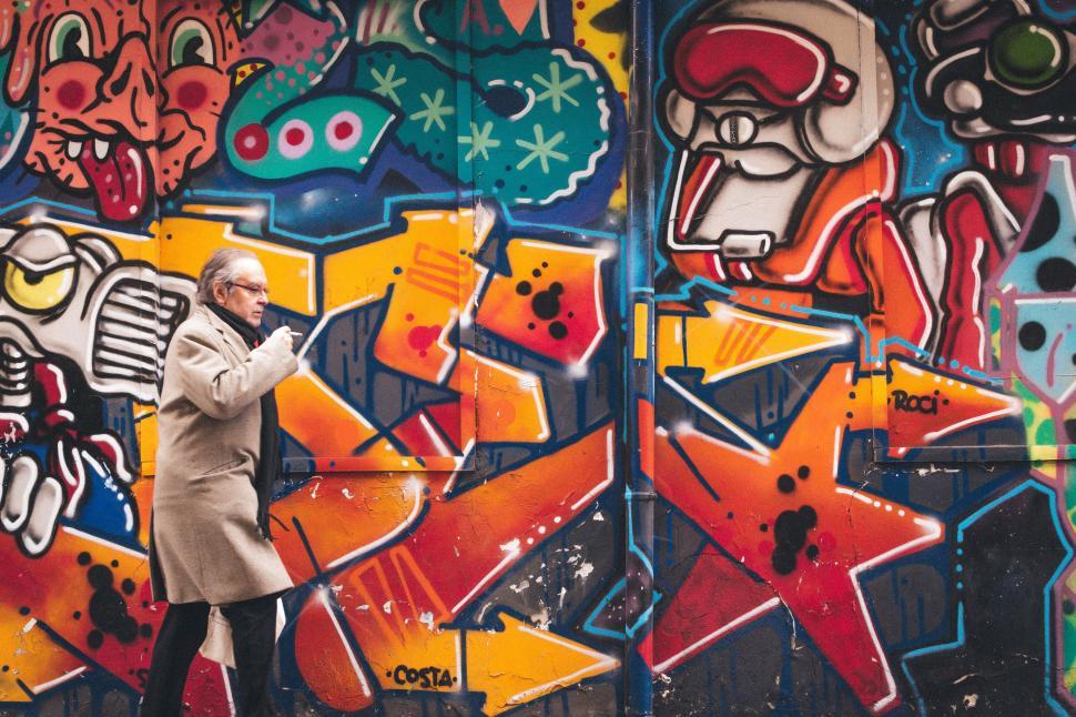 Free Image of Man Standing in Front of Graffiti-Covered Wall 