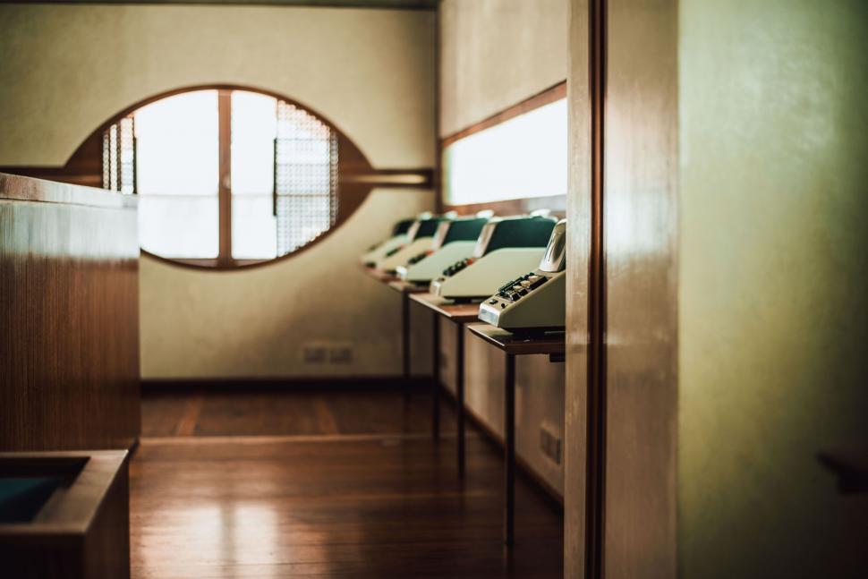 Free Image of A Row of Chairs by the Window 