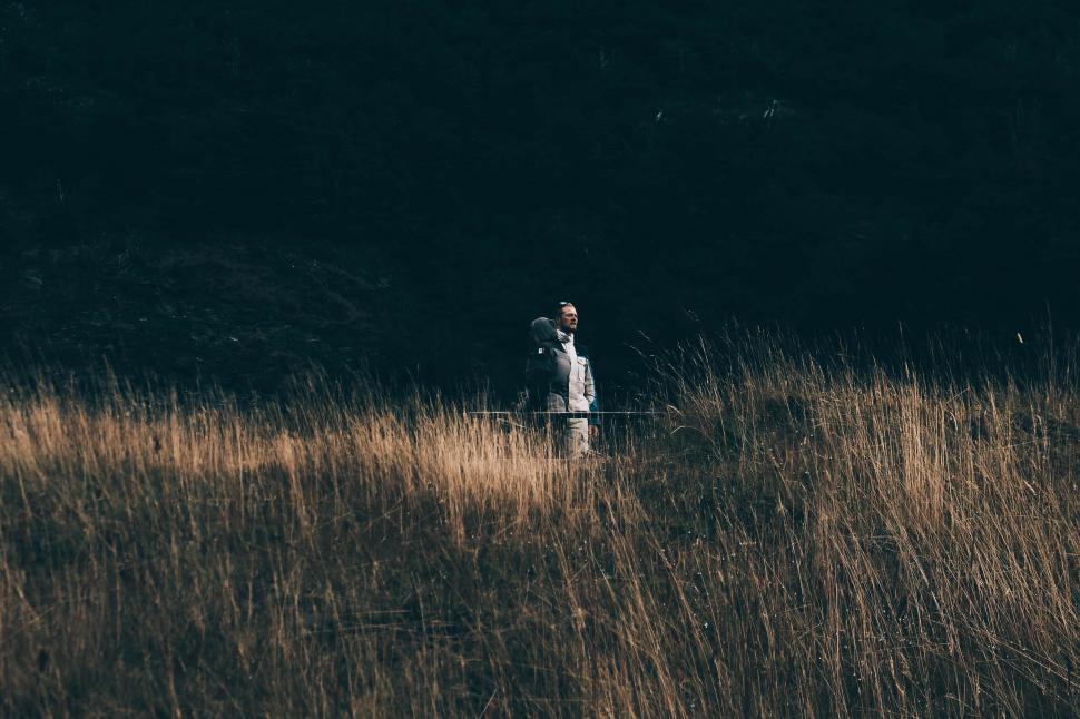 Free Image of Person Standing in a Field of Tall Grass 