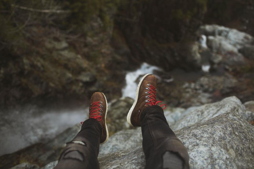 Free Image of Person Standing on Rock by River 