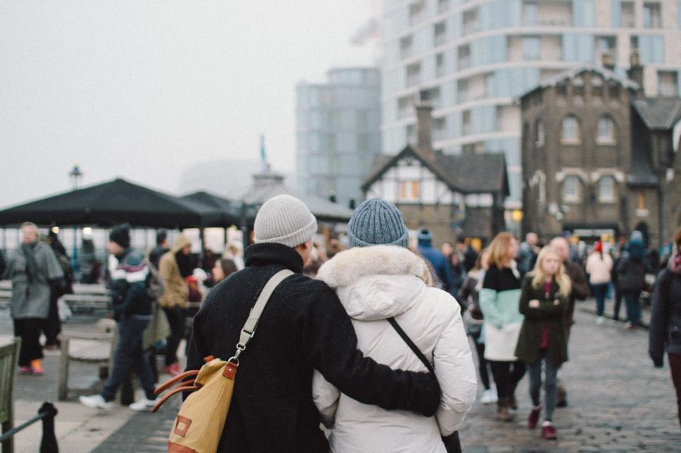 Free Image of Couple Walking Down Busy City Street 
