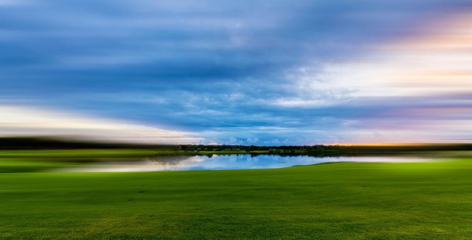 Free Image of Green Field With Lake in the Middle 