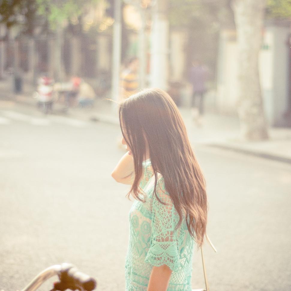 Free Image of Young Girl Standing Next to Teddy Bear 