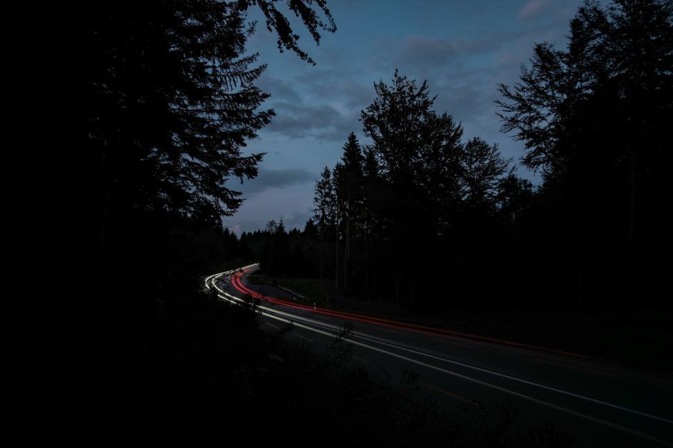 Free Image of Car Driving Down Road at Night 