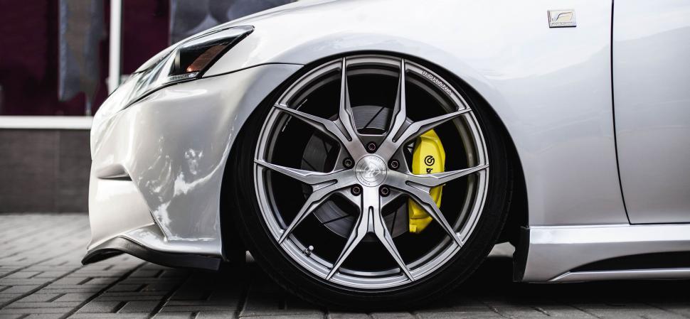 Free Image of Close Up of a White Car on a Brick Road 