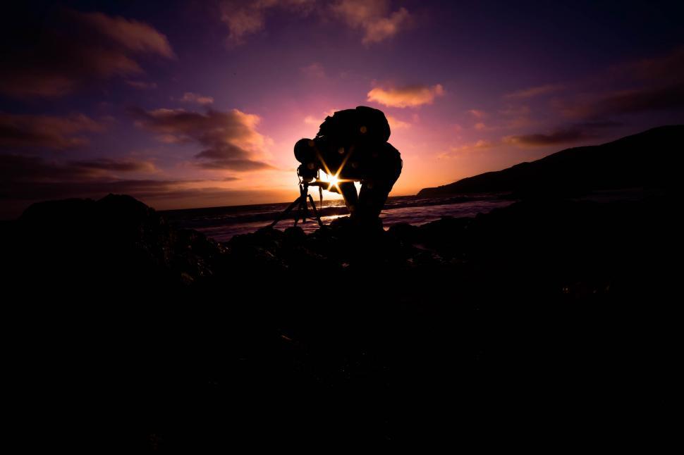 Free Image of Person Taking Picture of Sunset 